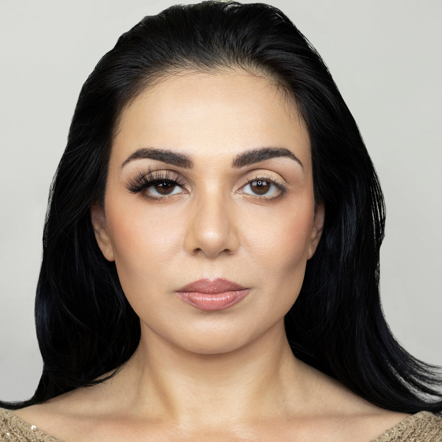 Full face of beautiful young woman wearing Suntarah Beauty 3D Faux Mink False Strip Eyelash in F-107 on right eye only.  Woman is looking straight ahead. Photos shows significant difference between eye appeal, with right eye appearing much more accentuated and cat eye like.  Right eye looks  glamorous, dramatic, and foxy. 
