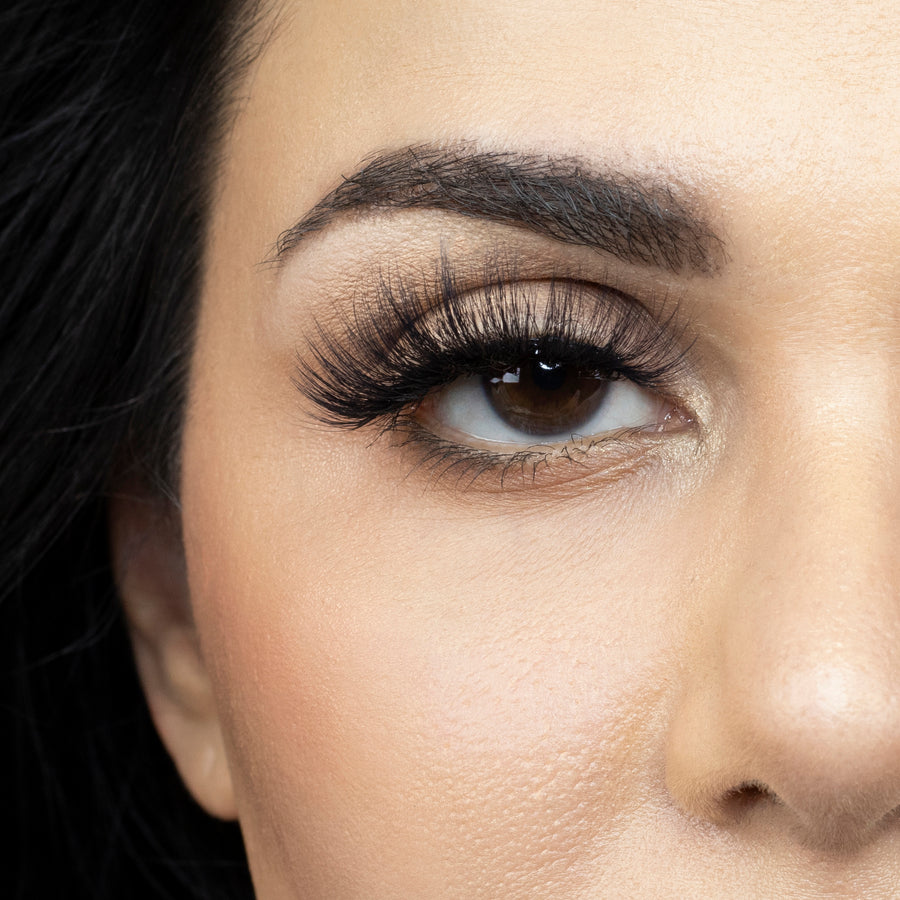 Close up of woman’s right eye while wearing Suntarah Beauty 3D Faux Mink False Strip Eyelash in F-107.  Woman is looking straight ahead. 