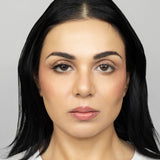 Full face of young beautiful woman wearing Suntarah Beauty Ultra Light Synthetic Strip Eyelash in Style SL-331 on right eye only.  There is a subtle difference in appeal between both her eyes.  Her right eye is  appears accentuated and slightly foxy with the airy and natural strip eyelash.