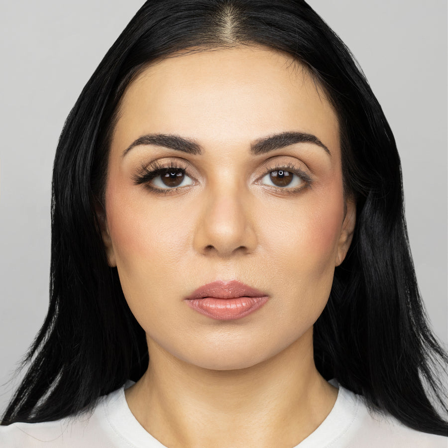 Full face of young beautiful woman wearing Suntarah Beauty Ultra Light Synthetic Strip Eyelash in Style SL-333 on right eye only.  There is a noticeable difference in appeal between both her eyes.  Her right eye is  appears accentuated with the slightly bold, wispy lash.